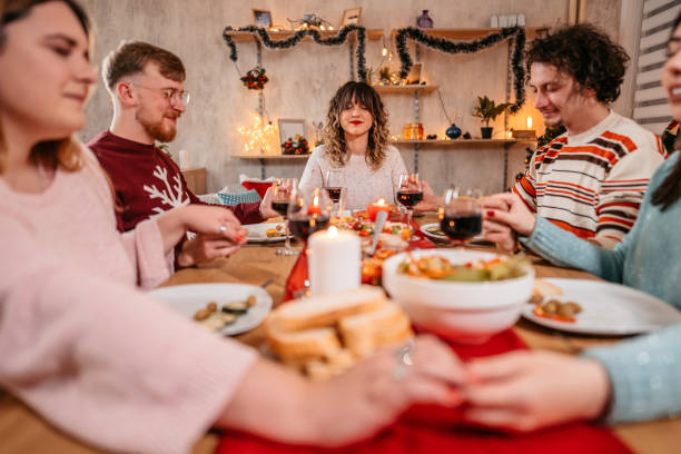 istock Friends prays before eating holiday dinner 1353967292