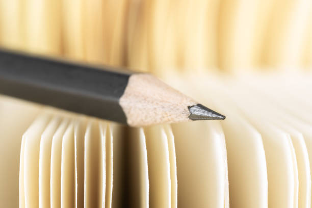 istock Pencil with selective focus and paper notebook in blurred background 1353967338