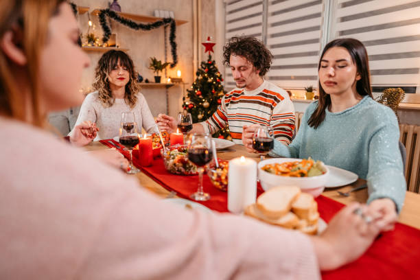 istock Friends prays before eating holiday dinner 1353967470