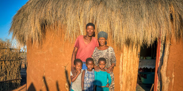 istock Three African kids together with the parents 1353967549