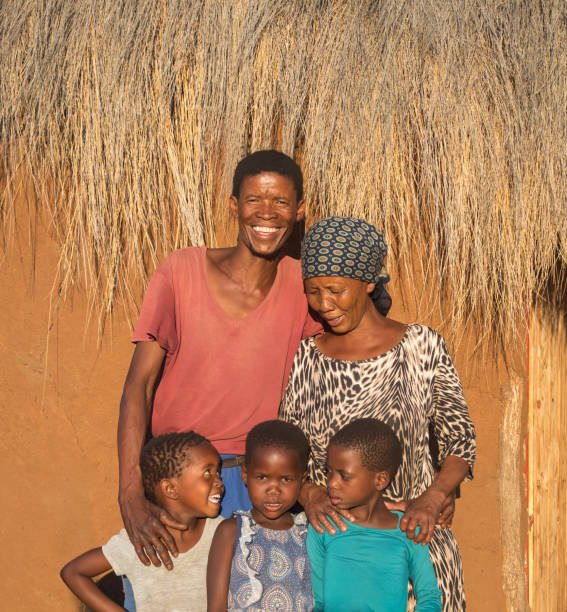 istock Three African kids together with the parents 1353967635