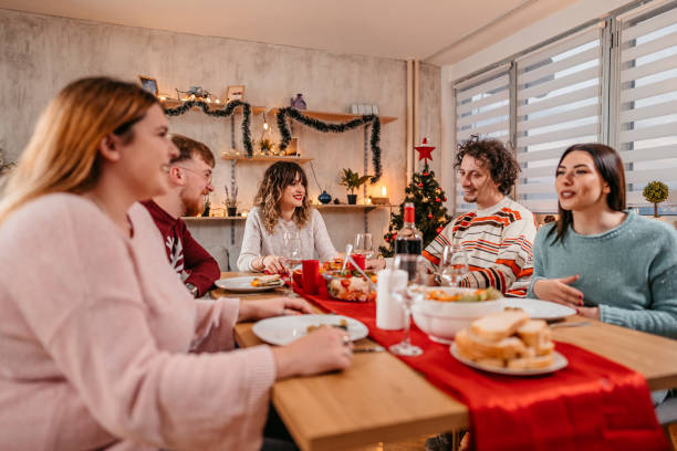 istock Friends having Christmas dinner together 1353968404