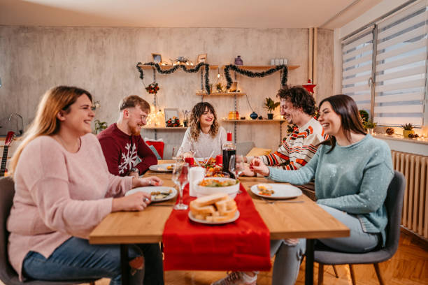istock Friends having Christmas dinner together 1353968441