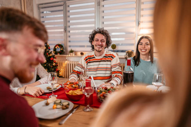 istock Friends having Christmas dinner together 1353968473