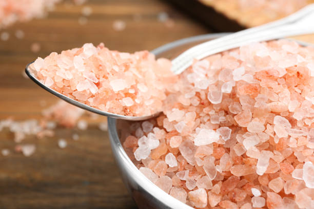 istock Glass bowl and spoon with pink himalayan salt, closeup 1353968513