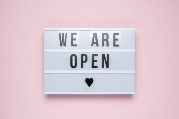 istock Lightbox with the text WE ARE OPEN on pastel pink background. Minimal concept. 1353970057