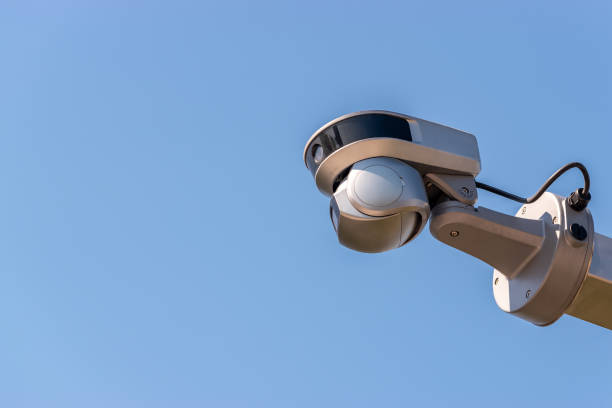 istock Street surveillance camera on sky background. 1353970091