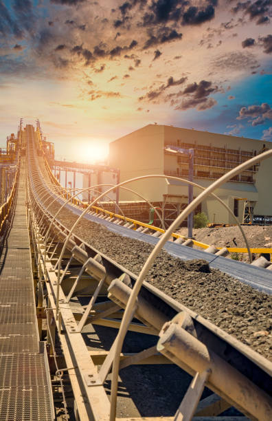 a huge conveyor belt at the sunset in a diamond mine a huge conveyor belt at the sunset in a diamond mine in Botswana mining conveyor belt stock pictures, royalty-free photos & images