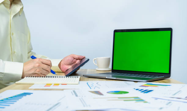 istock green screen on laptop and man working and writing 1353974212