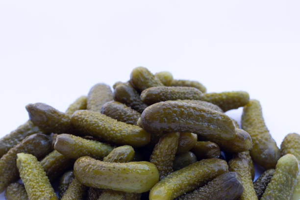 istock Pickled gherkins or cucumbers on white background. 1353974268