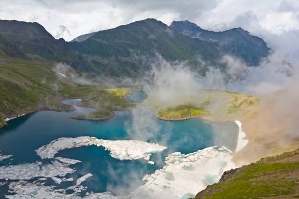 istock mountain lake in a mist 1353975779