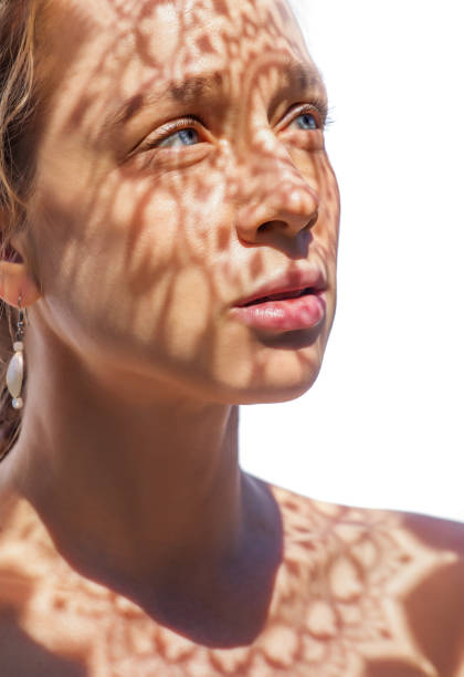 istock Headshot of a female face behind summer shadow 1353975808