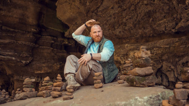 istock Redhead man practicing yoga in the nature 1353975905