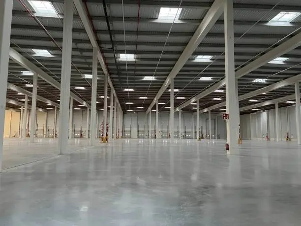 View of the interior of an empty modern factory or warehouse. Industry concept.