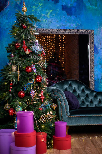 istock Christmas tree with decorations and presents under it in interior. 1353977257