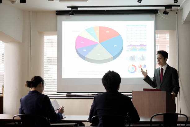 istock Asian businessman giving a presentation at a conference 1353977344