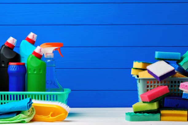 istock Various cleaning items against blue wooden background 1353977346
