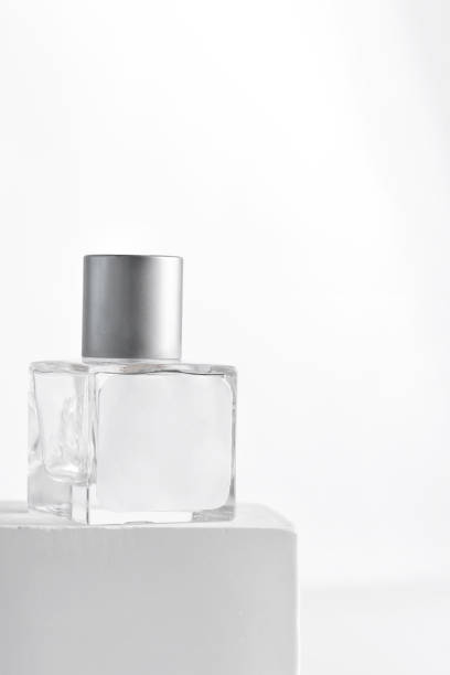 istock glass product package aroma perfume bottle on stand with sunlight, 1353977404