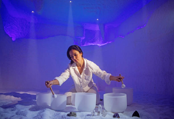 sound healing ritual for an individual instructor in a health spa salt cave - new age music imagens e fotografias de stock