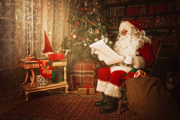istock Santa Claus reading from a Christmas wish list 1353981248
