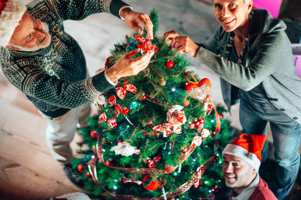 istock happy family decorating the christmas tree 1353981366