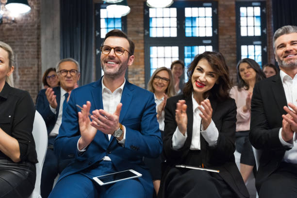 istock Cheerful audience during business seminar 1353981395