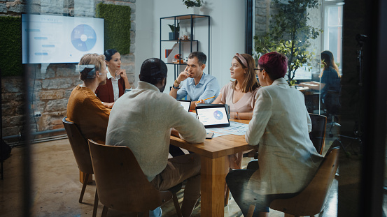 Mixed group of business persons having a meeting