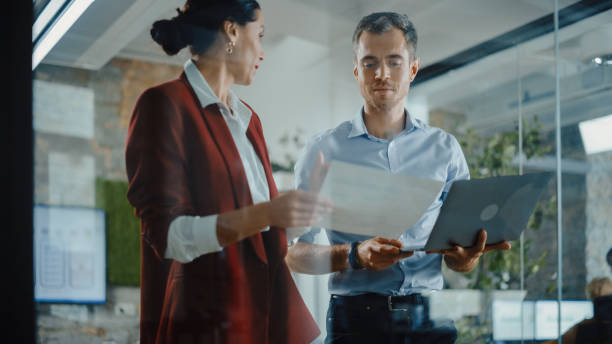 istock CEO and Chief Executive Talking About Company Business Growth, Consult Data Analysis and Use Laptop Computer. Two Professionals Discussing Revenue Increase, Market Disruption, Planning Strategy 1353983640