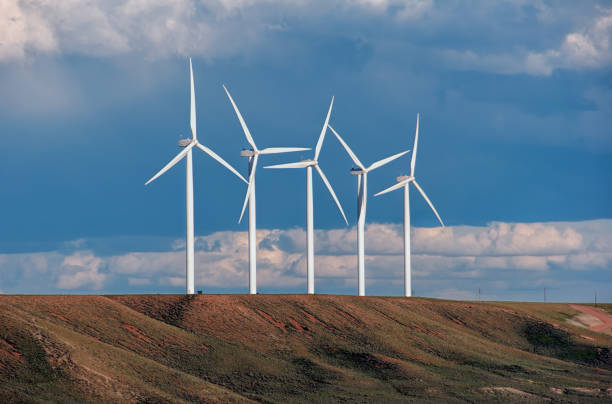 Wyoming Windmills A glimpse at a windfarm in Wyoming, USA. A few of many thousands of power generating windmills that now cover the landscape. wyoming stock pictures, royalty-free photos & images