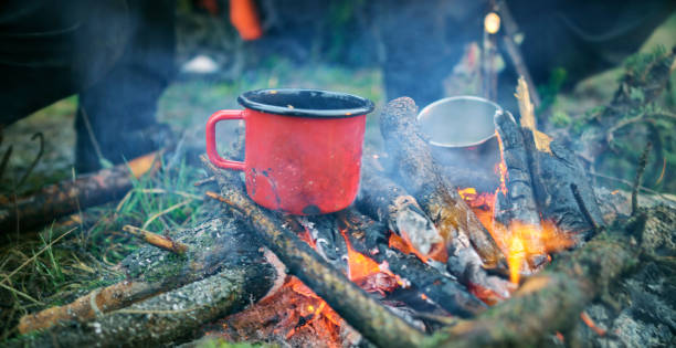 istock Close-up of cups placing on campfire 1353987018