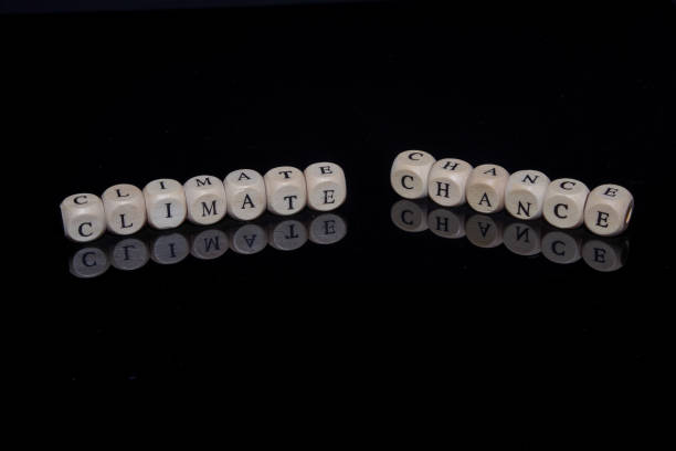 istock Letter cubes form the words Climate Chance against a black, reflective background 1353987114