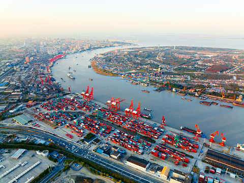 Top view of deep water port with cargo ship and containers in Shanghai.