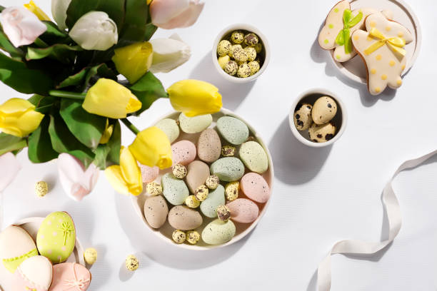 istock Easter color eggs in a Bowl with tulips, flat lay 1353988202