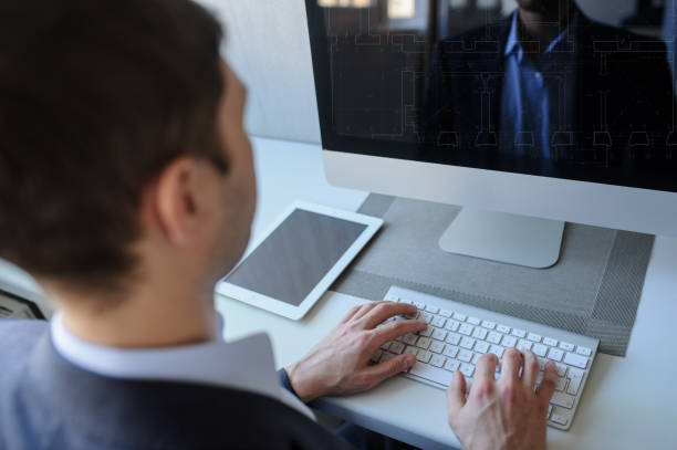 istock young man working on the computer in a light gray room 1353989275