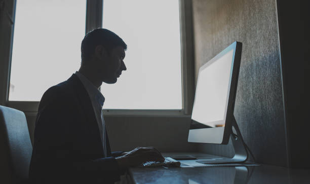 istock young man working on the computer in a light gray room 1353989289