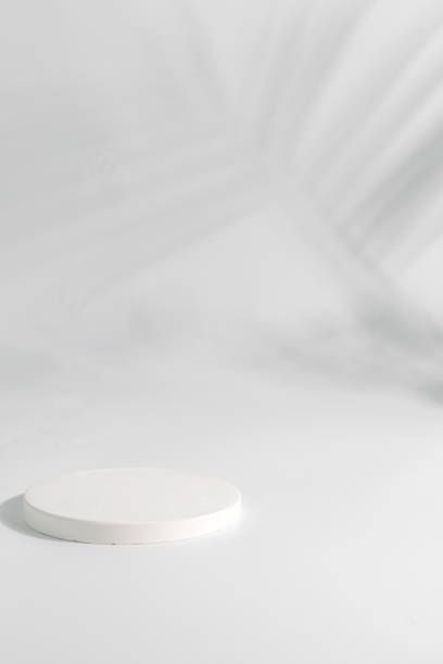 istock Podium for packaging presentation and cosmetic, tropical leaf shadow on a wall. 1353989642