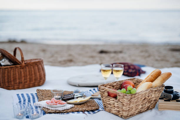istock Beach picnic with schripms, beer, fruit and candles 1353990693