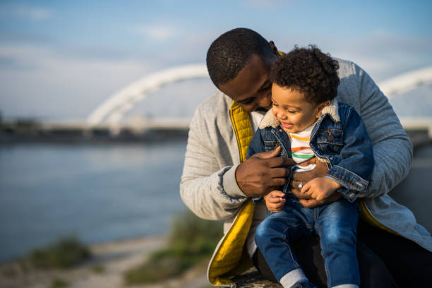 Happy father and his son enjoy spending time together outdoor.