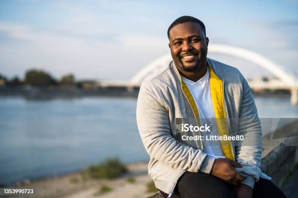 Modern Black Man Resting By The River Stock Photo - Download Image Now - Men, Overweight, African-American Ethnicity