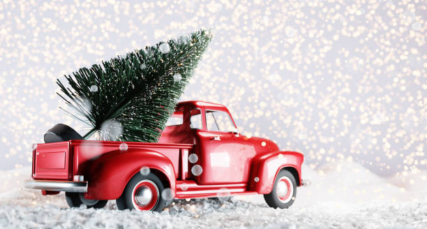 istock Christmas tree on red toy car trunk 1353990783