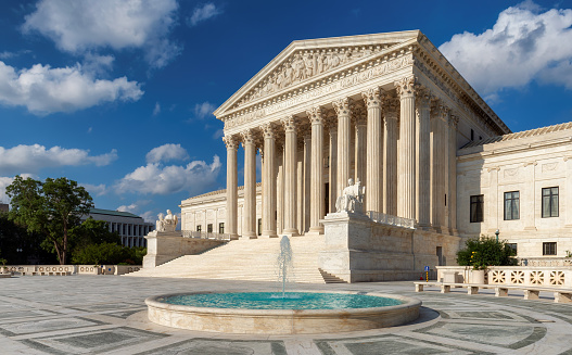 The United States Supreme Court Building at summer day in Washington DC, USA.