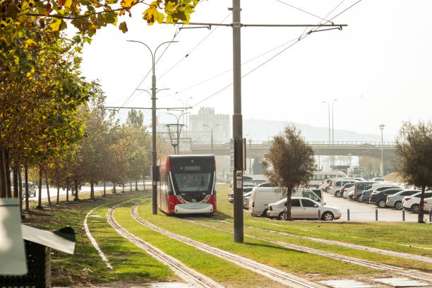 Munich, Germany - December 24, 2015: View of the tram operating it's daily course along with people, cars, buildings and nature.