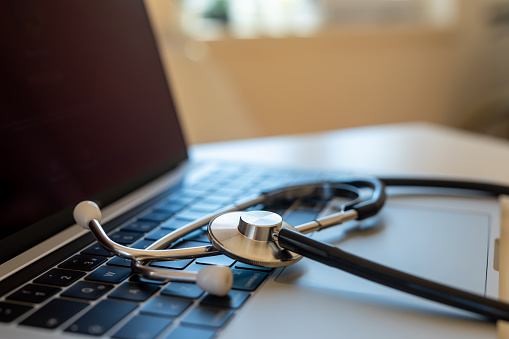 Stethoscope on doctor desk with labtop