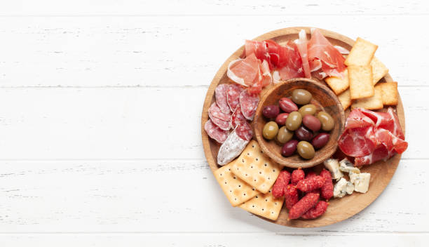 istock Antipasto board with prosciutto, salami, crackers, cheese, olives 1353993139