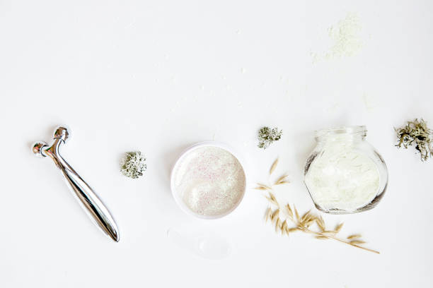 istock Face care cosmetics set. Massager, alginate mask and patches. Dermatology multiuse cosmetics, multitasking beauty. Scinimalism concept, polytasking functions. Natural eco forest moss and oat 1353994111
