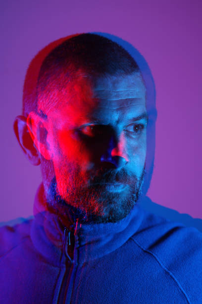 istock Portrait of a man with neon light 1353994332