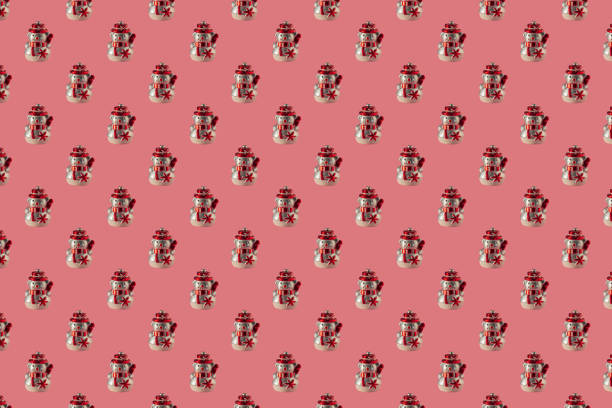 Christmas seamless pattern with snowmen on a pink surface. Winter pattern on a pastel pink background. Christmas ball snowman. Template for wallpaper, holiday packaging