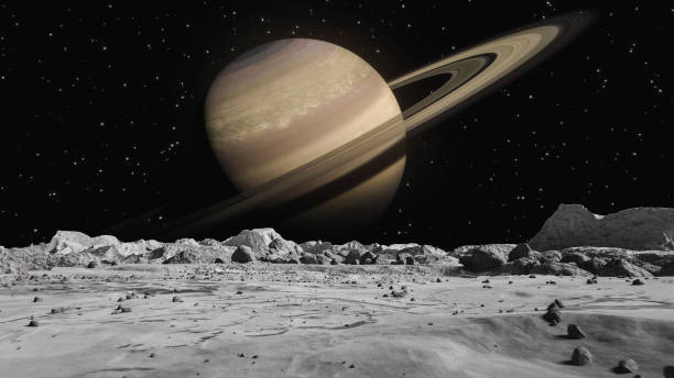 istock Planet Saturn as viewed from Moon surface. The surface of Moon, strewn with small rocks and sand. Flight over Moon craters. Conception space abstract background. 1353996903