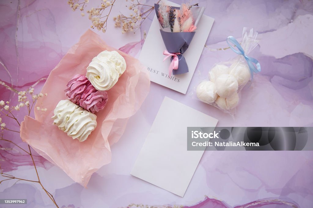 Delicate pink and white marshmallow with decoration of gypsophila and dryflowers bouquet. Mock up card. Feminine background, template. Cozy winter weekends. Homemade sweets Delicate pink and white marshmallow with decoration of gypsophila and dryflowers bouquet. Mock up card. Feminine background, template. Cozy winter weekends. Homemade sweets. High quality photo Buttercream Stock Photo