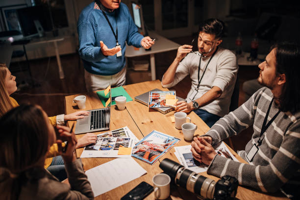 istock Journalists team on late meeting 1353999205